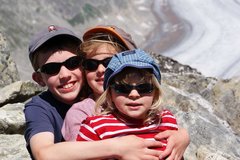 Drei Kinder mit Sonnenbrillen im Gebirge